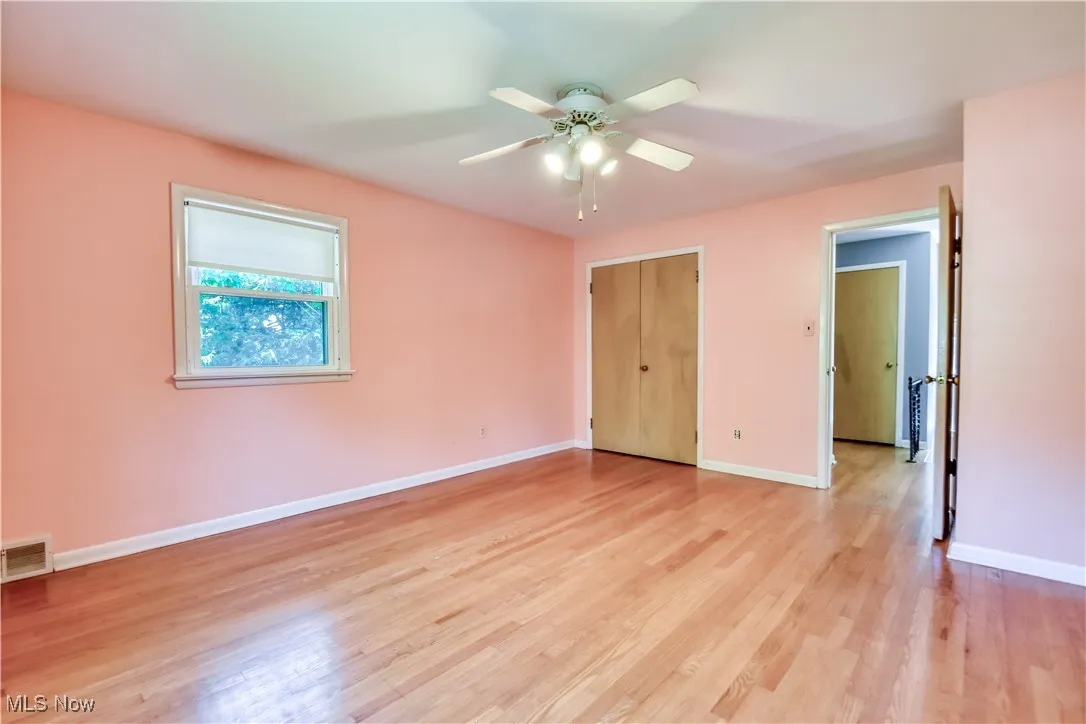 Unfurnished bedroom featuring light wood finished floors and a ceiling fan