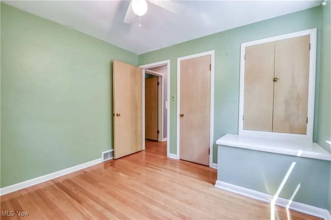 Unfurnished bedroom featuring light wood-style flooring and ceiling fan