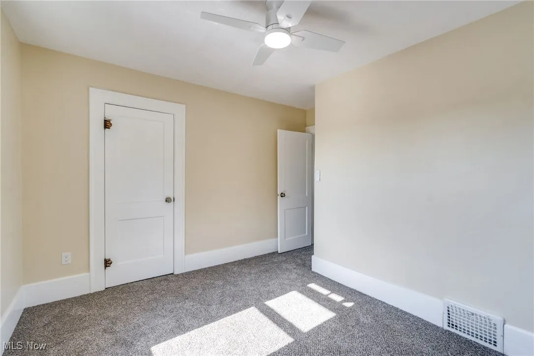 Unfurnished bedroom featuring carpet floors and a ceiling fan