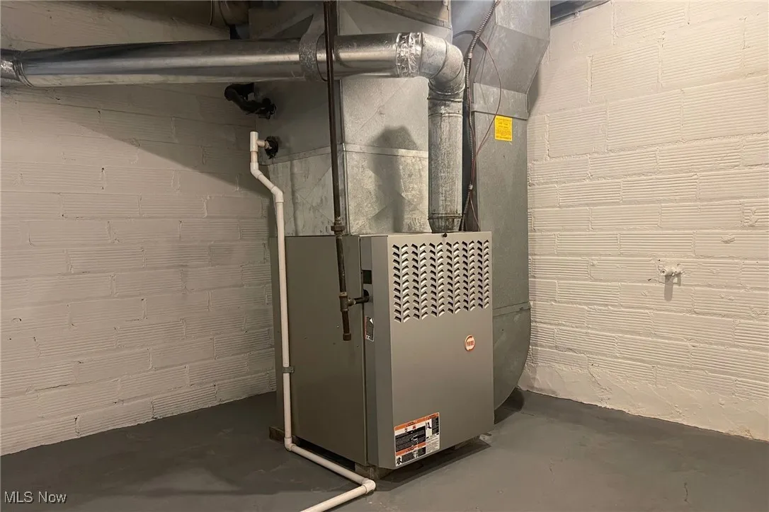 Utility room featuring heating unit