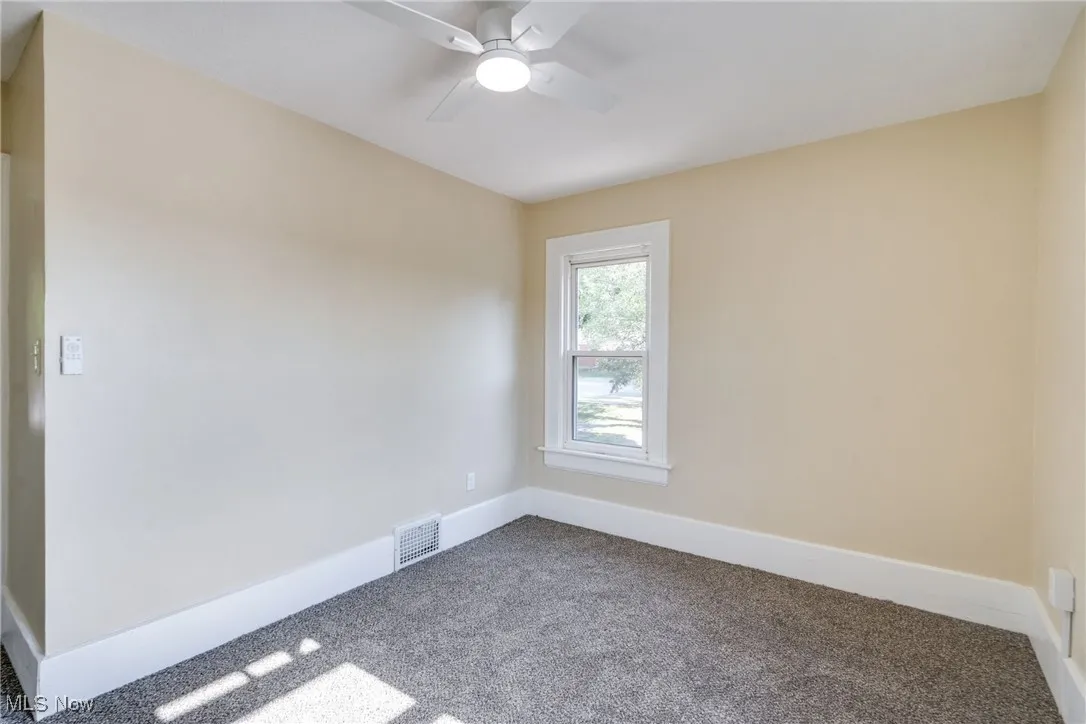 Spare room with carpet and ceiling fan