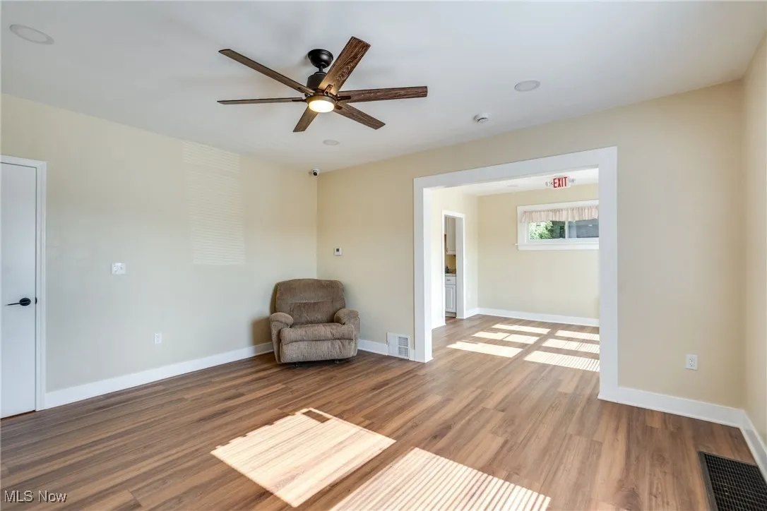 Unfurnished room featuring wood finished floors and a ceiling fan