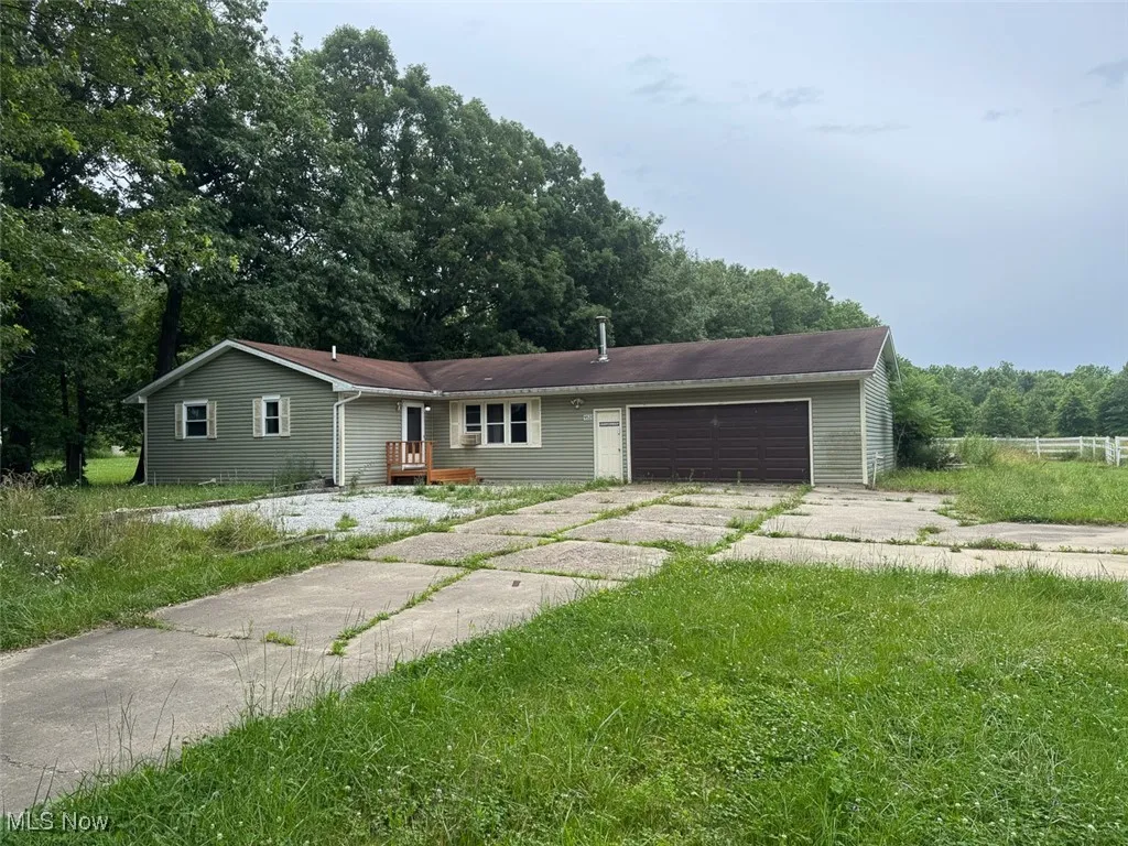 Ranch-style home with a garage and concrete driveway
