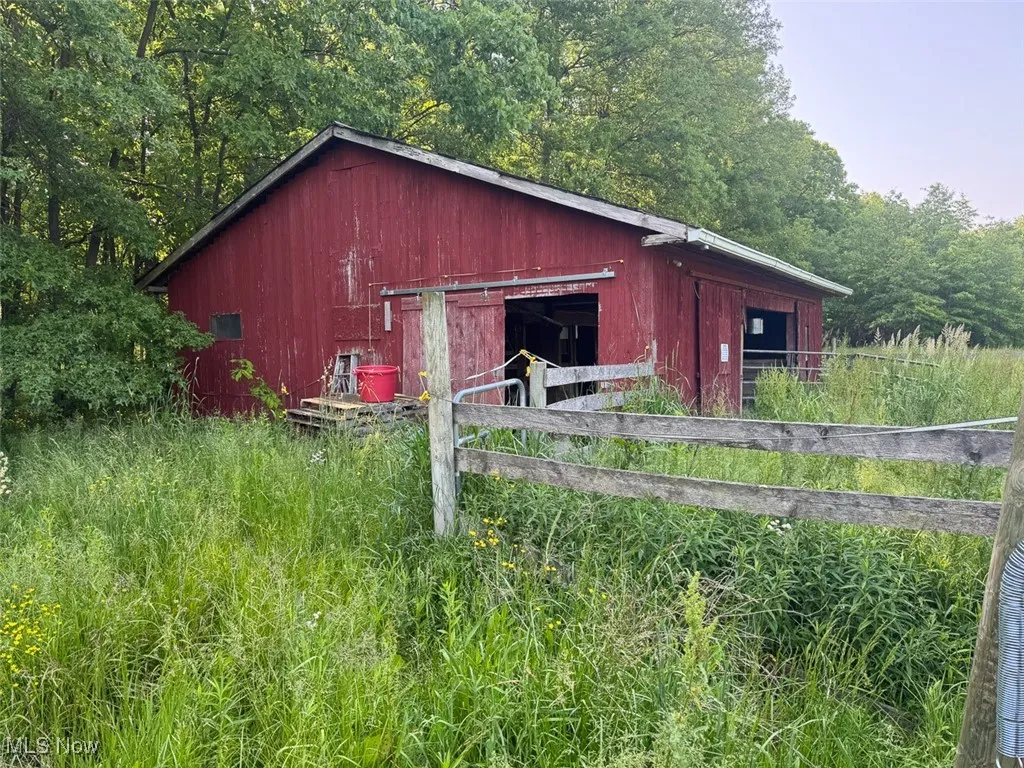 View of horse barn with a view of trees
