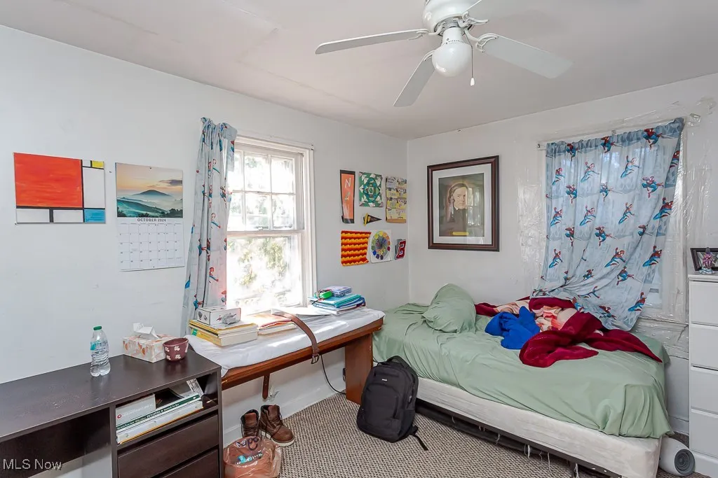 Bedroom with carpet and a ceiling fan