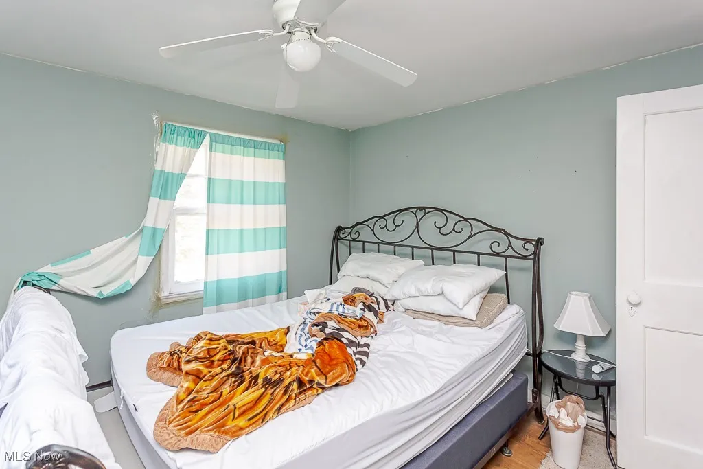 Bedroom featuring a ceiling fan and wood finished floors