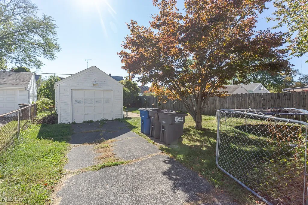 Detached garage featuring asphalt driveway