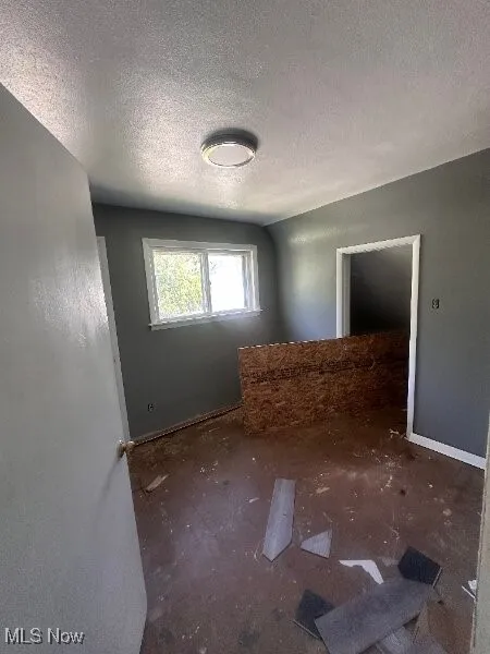 Spare room with a textured ceiling