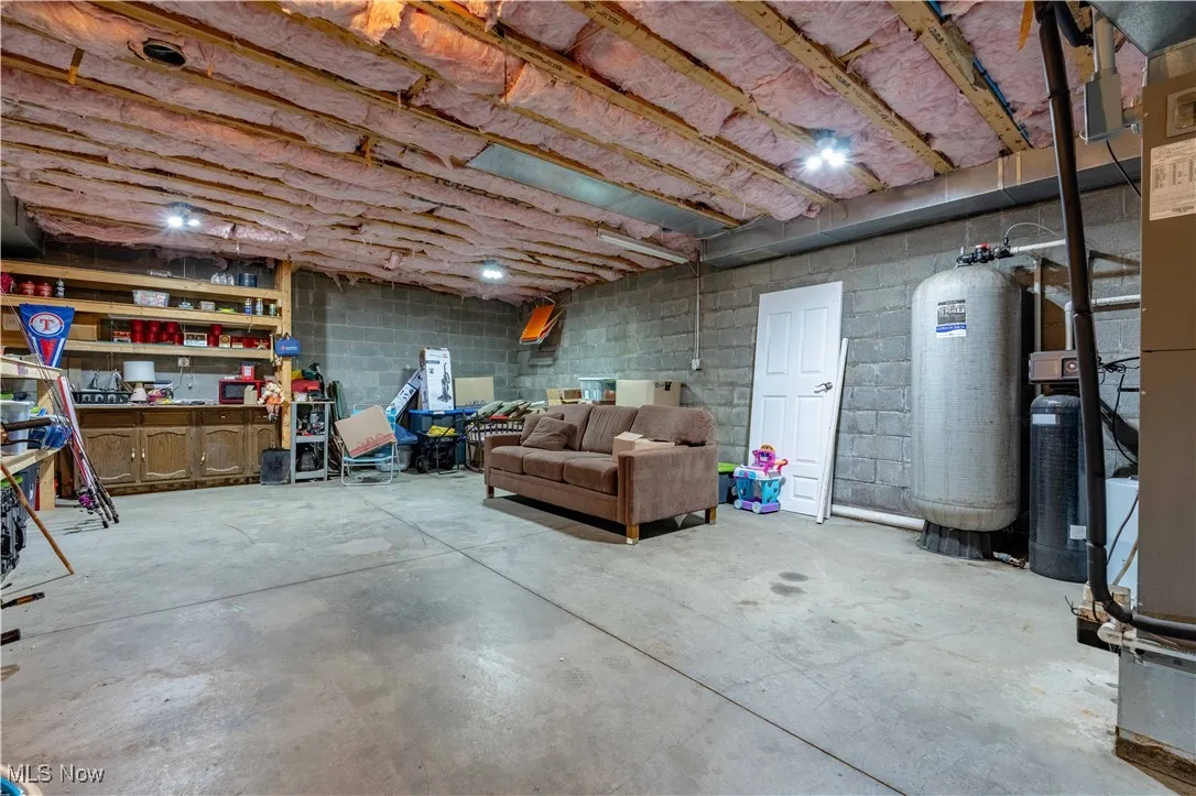 Unfinished basement with concrete block wall
