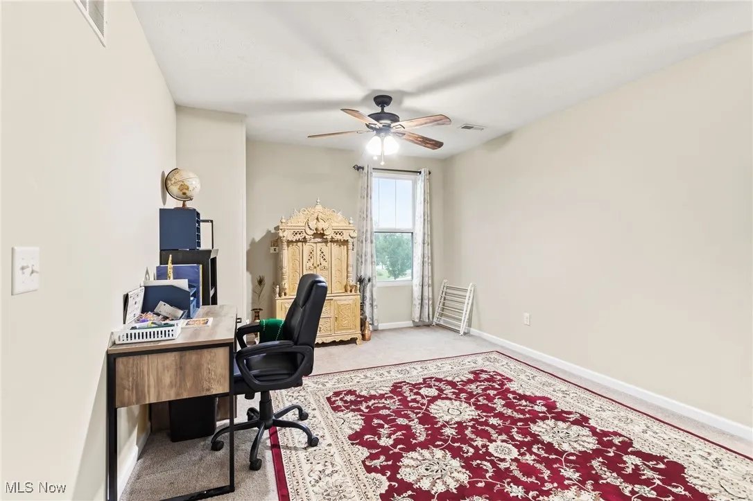 Office space featuring carpet and a ceiling fan