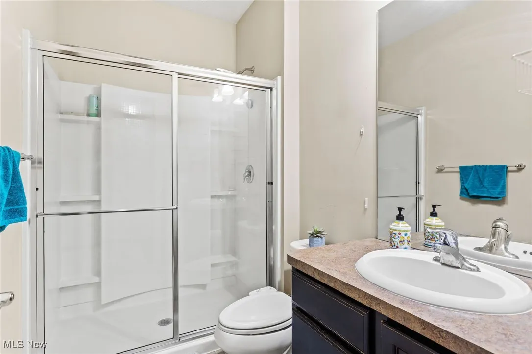 Full bath with a stall shower and vanity
