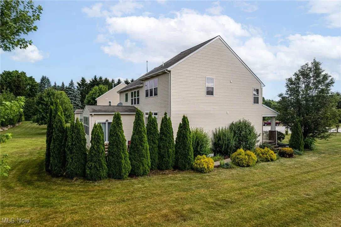 View of property exterior with a yard