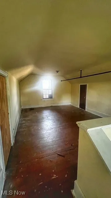 Bonus room featuring wood finished floors and lofted ceiling