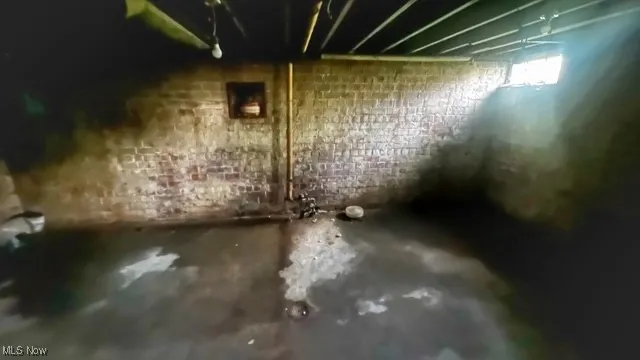 Below grade area featuring brick wall