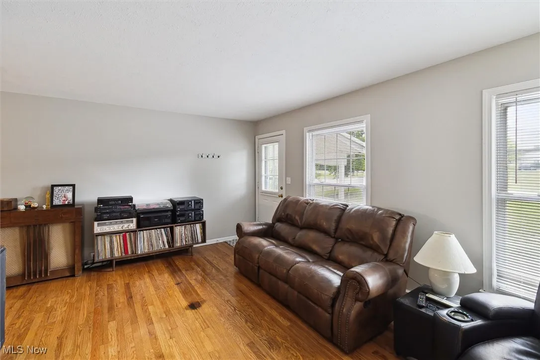 Living room with wood finished floors and healthy amount of natural light