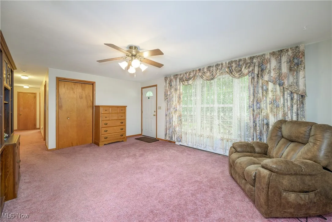 Sitting room with ceiling fan and carpet flooring