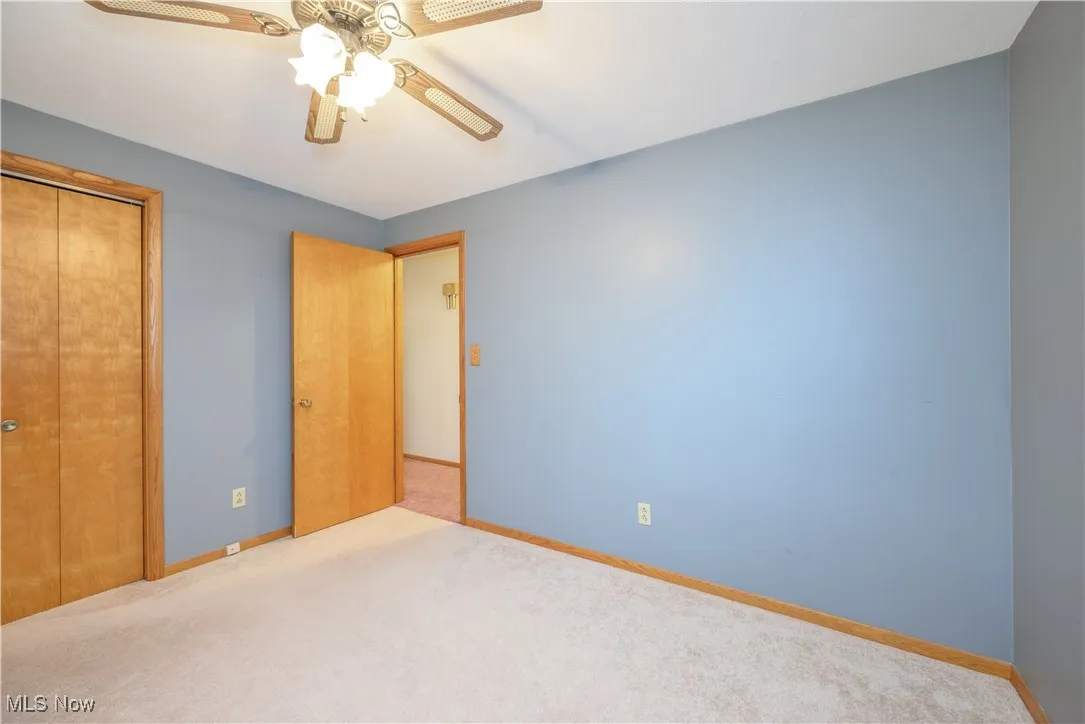 Unfurnished bedroom with carpet floors, a closet, and ceiling fan