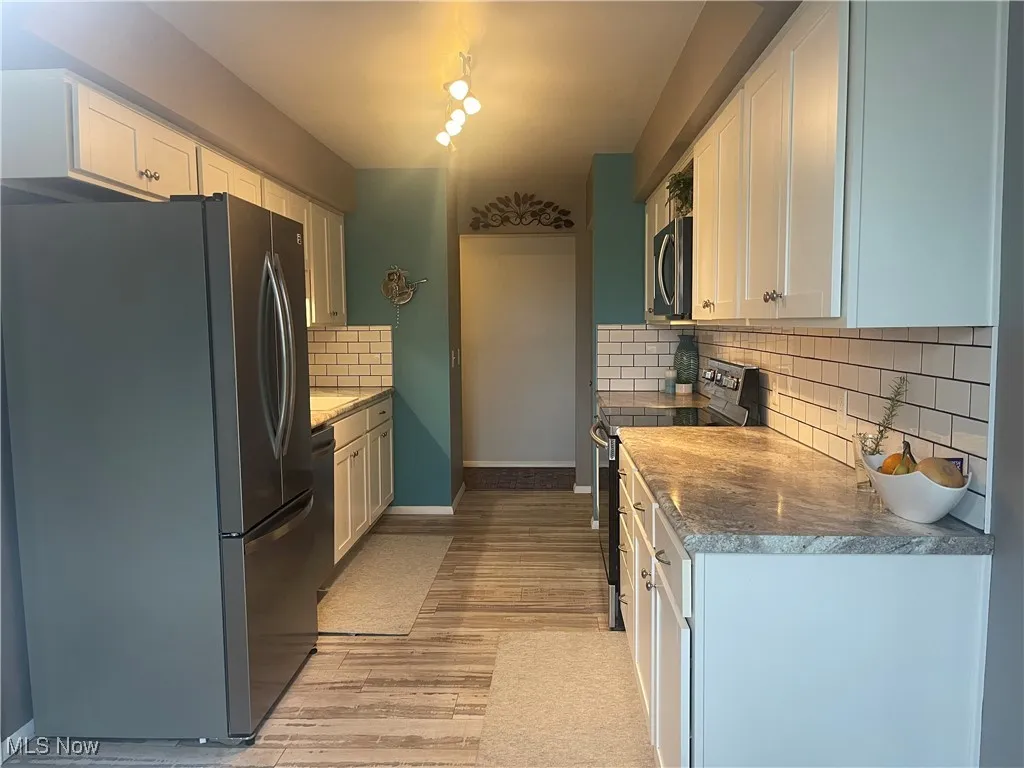 From eating area to hall way to Master Bedroom.  There is a large pantry at the end of the kitchen before exiting.