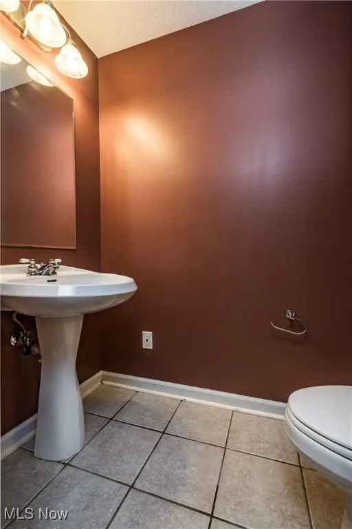Bathroom featuring baseboards and tile patterned flooring