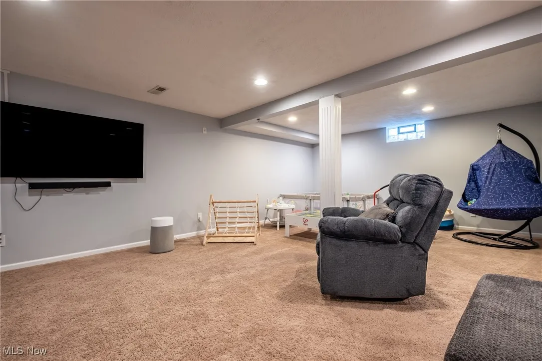 Living area featuring carpet and recessed lighting
