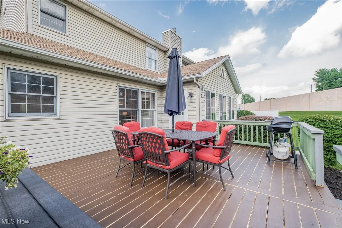 Wooden deck with area for grilling and outdoor dining space