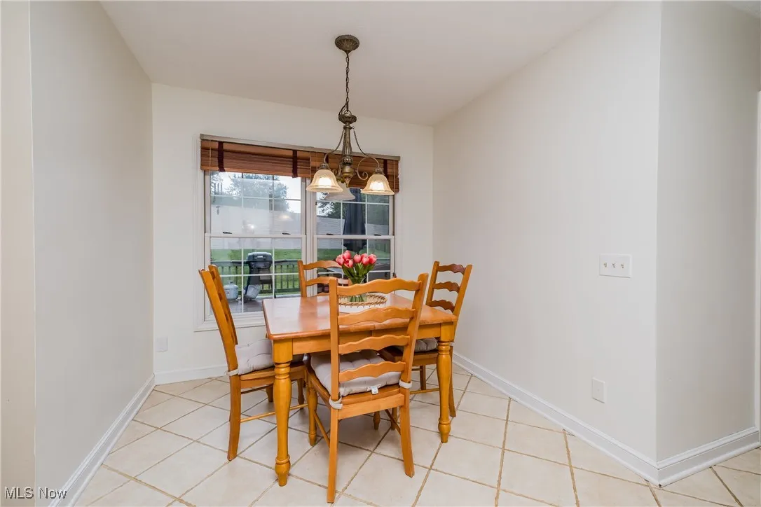 Dining space with light tile patterned floors