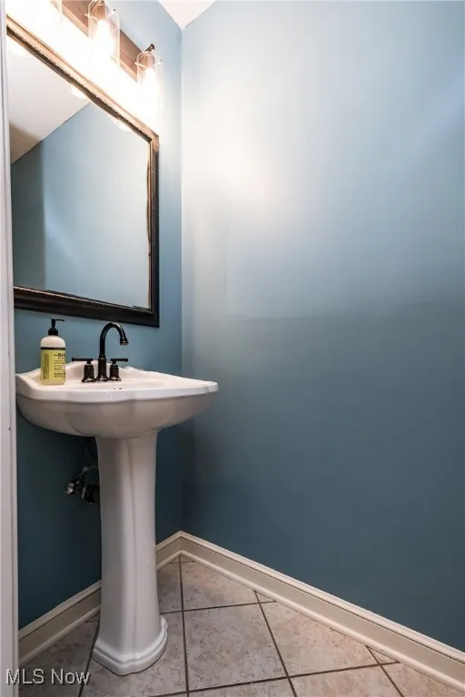 Bathroom featuring tile patterned floors and baseboards