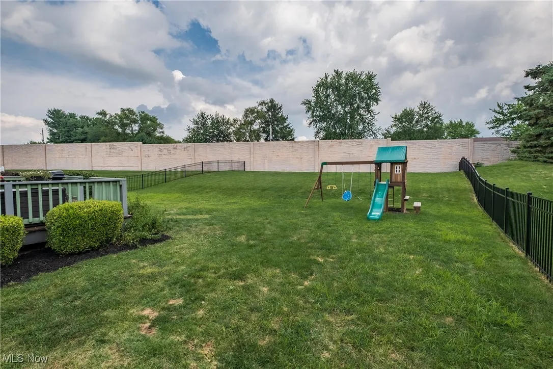 Fenced backyard with a playground