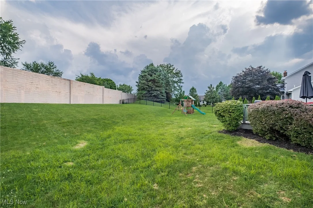 Fenced backyard with a playground