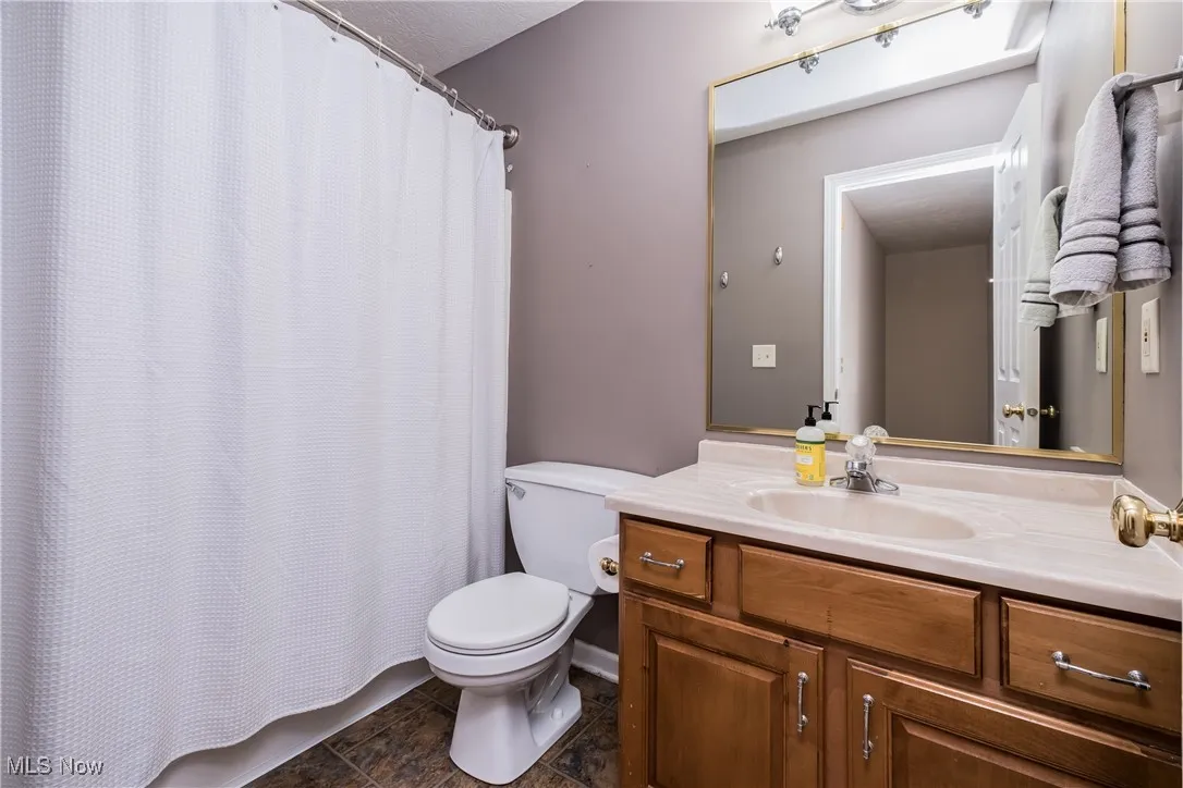Full bath with toilet and vanity