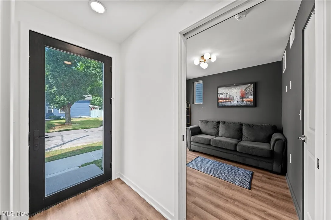 Foyer with light wood-type flooring and baseboards