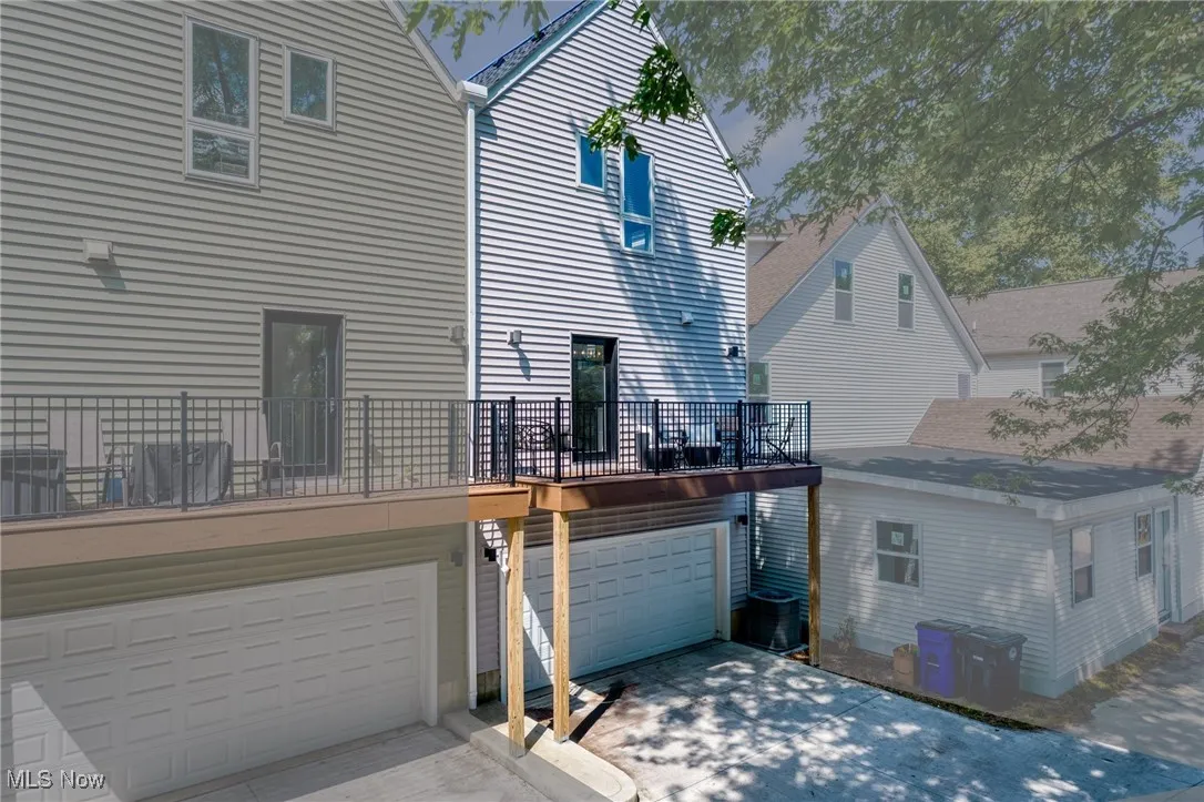 Rear view of house with a garage and concrete driveway