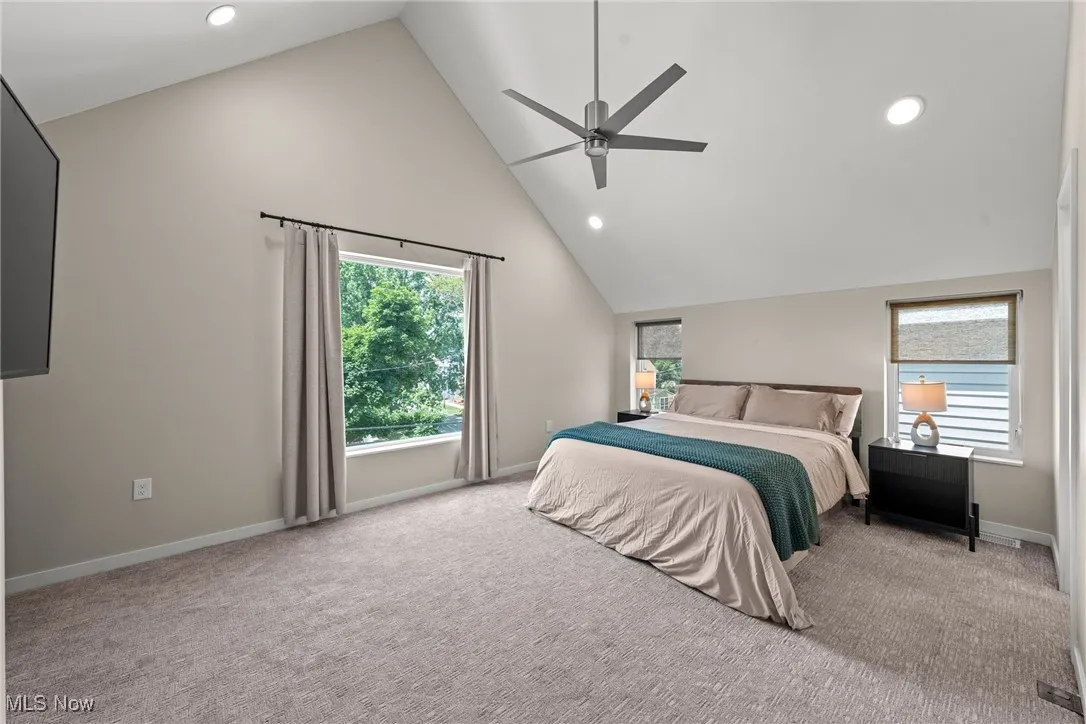 Bedroom featuring vaulted ceiling, carpet flooring, recessed lighting, and ceiling fan