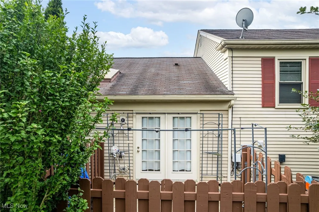 View of side of property with a shingled roof