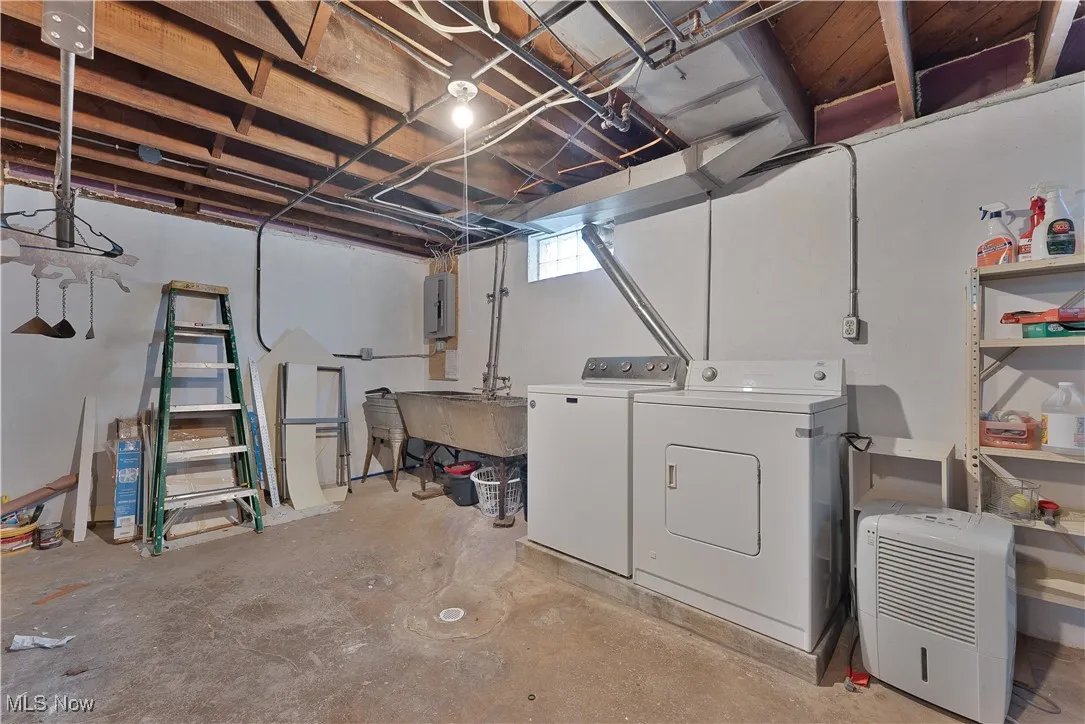 Below grade area featuring washer and clothes dryer and electric panel