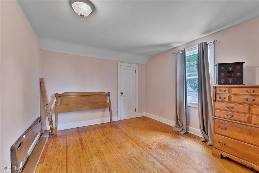 Unfurnished bedroom with light wood-style flooring and baseboards