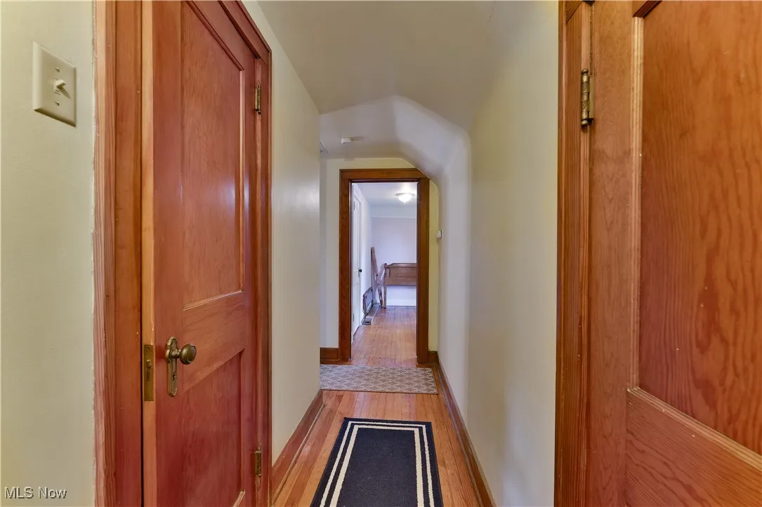 Hall featuring wood finished floors and baseboards