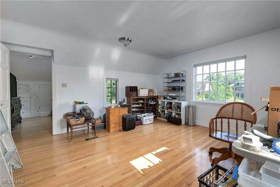 Office featuring wood finished floors and lofted ceiling