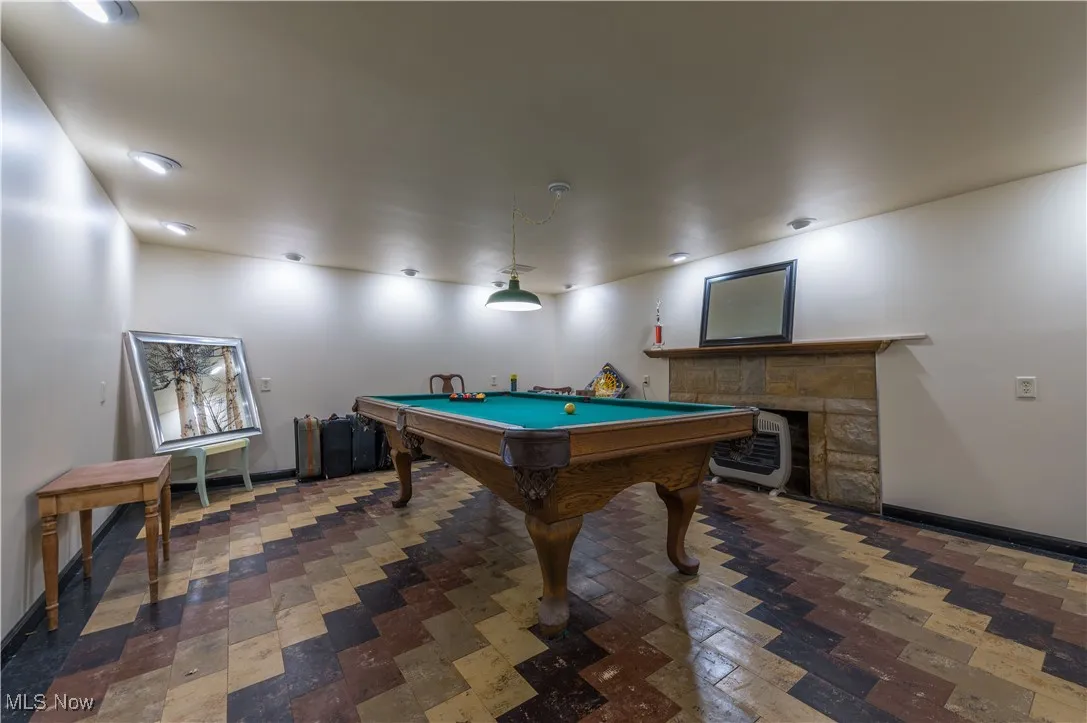 Game room featuring billiards and a fireplace