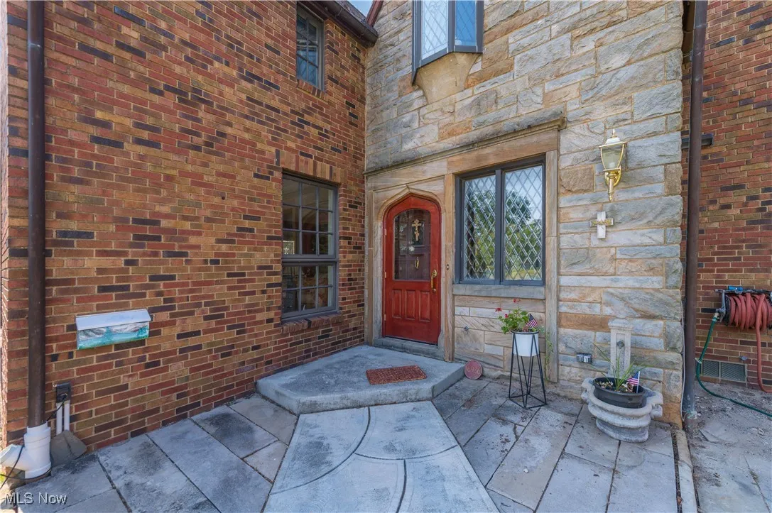Doorway to property featuring stone siding