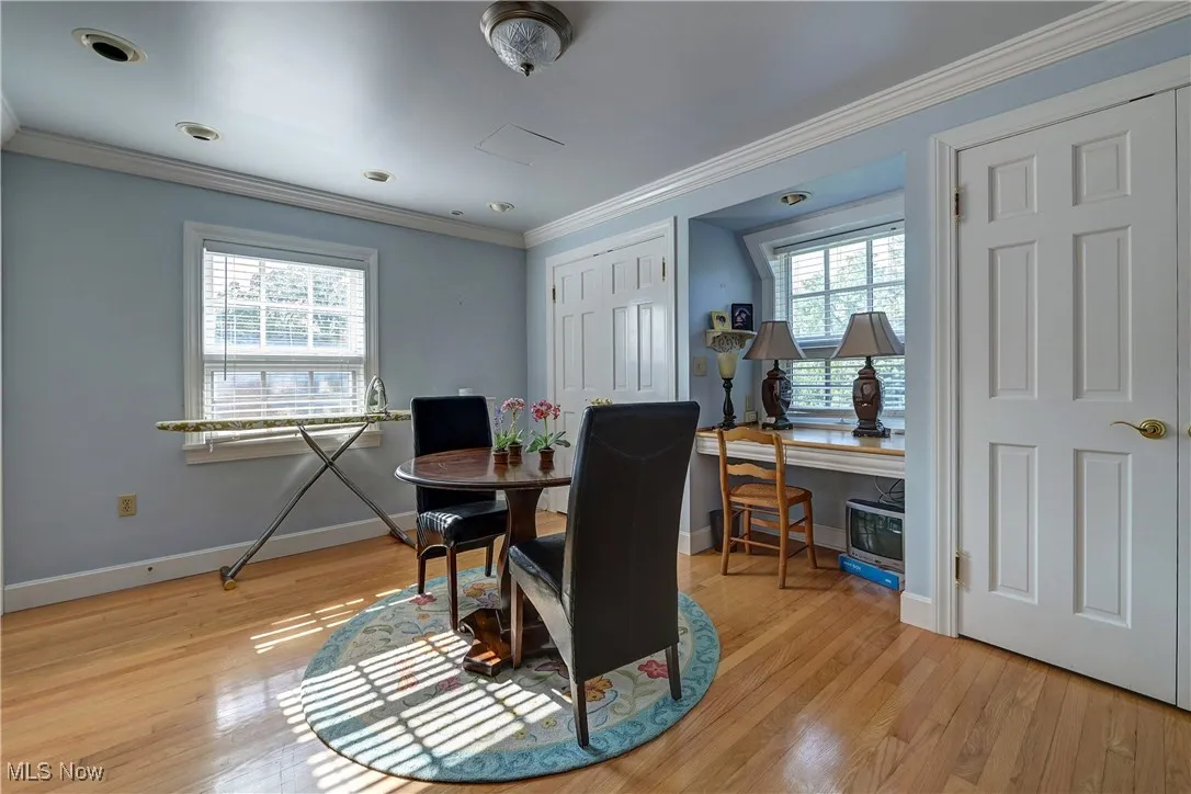 Dining room featuring light wood-type flooring and crown molding