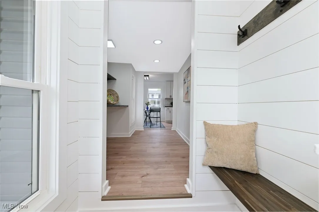 *NEAR THE SIDE DOOR IS A BENCH AND HOOKS FROM THE SIDE ENTRYWAY AS WELL. SHIPLAPPED WALL
