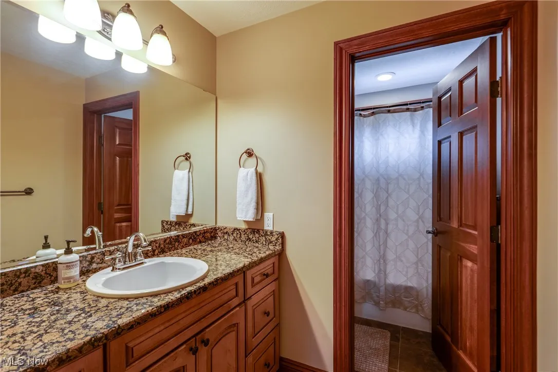 Full bathroom featuring vanity and tile patterned floors