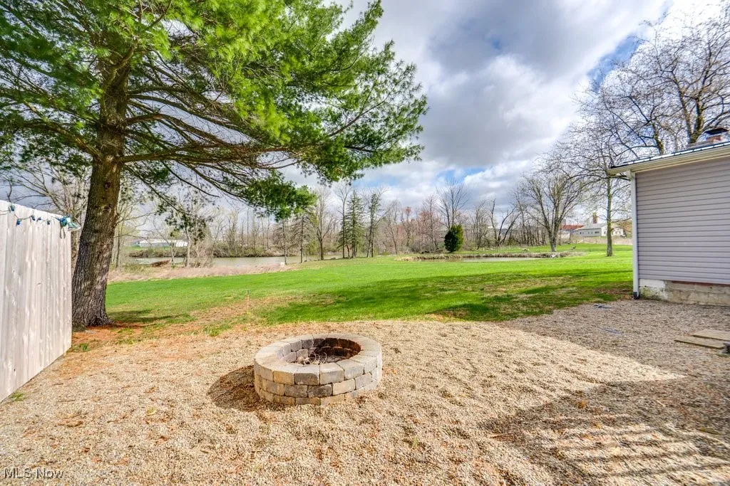 View of yard with an outdoor fire pit