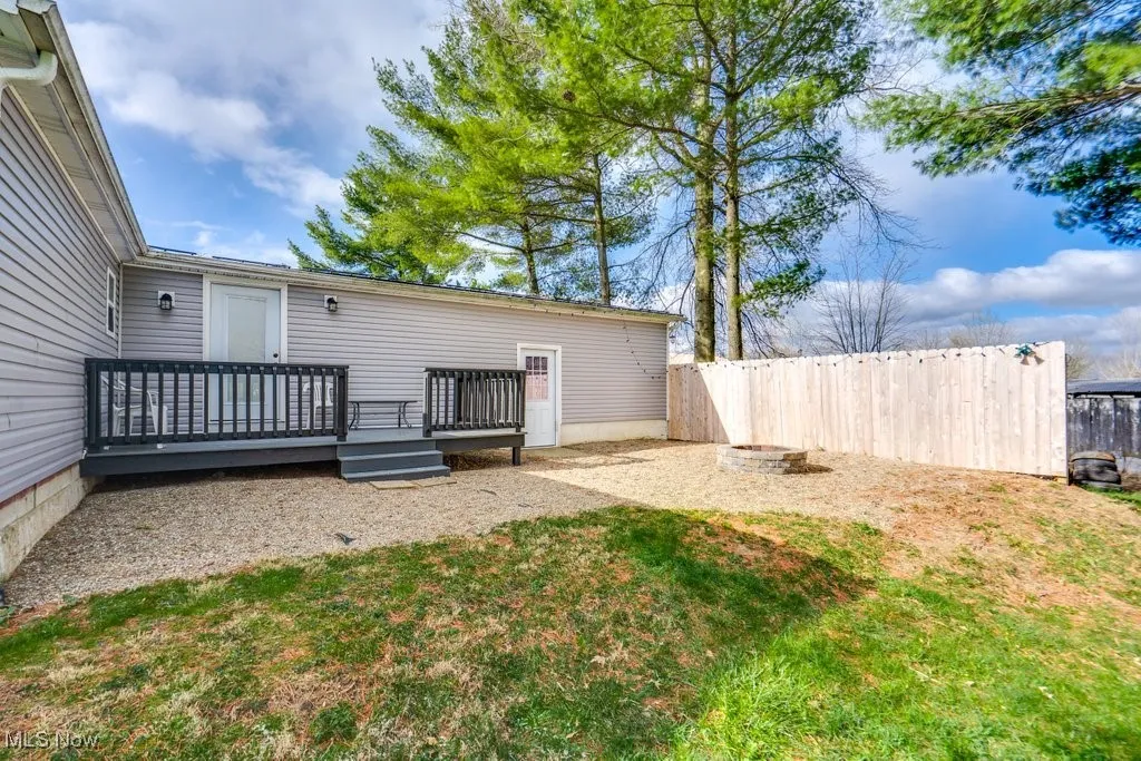 View of yard featuring fence and a deck
