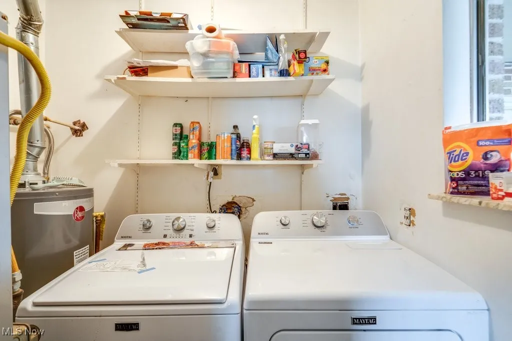 Washroom featuring laundry area, separate washer and dryer, and gas water heater