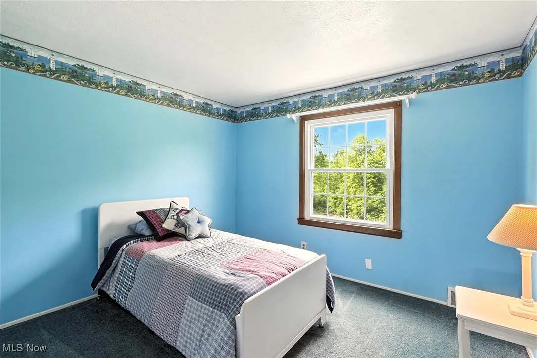 Carpeted bedroom featuring baseboards