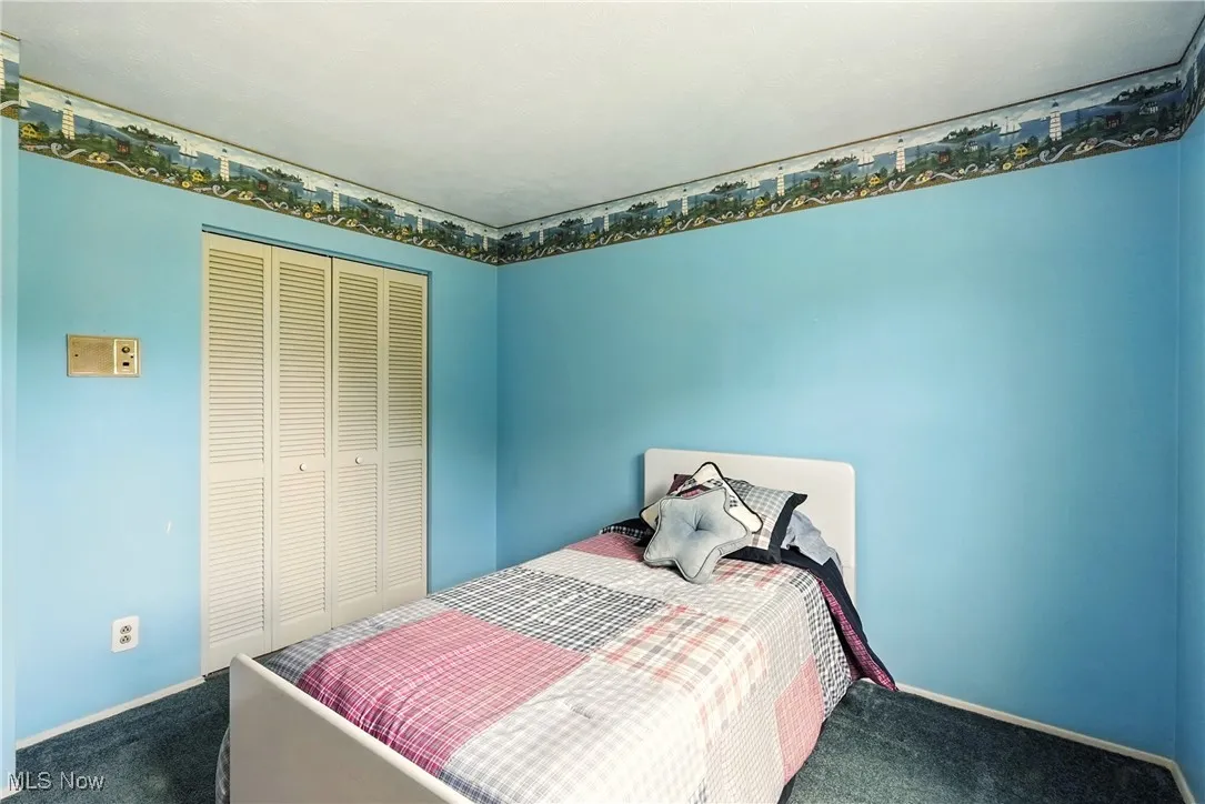 Bedroom featuring carpet flooring and a closet