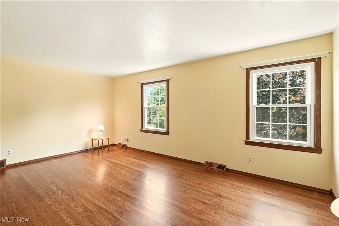 Unfurnished room featuring wood finished floors and baseboards