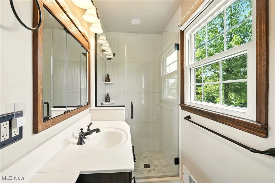 Bathroom with a shower stall and vanity